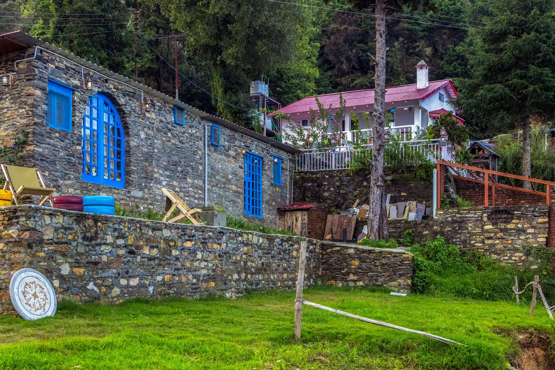 Lush green garden area and outdoor seating at Stone Heritage Mukteshwar