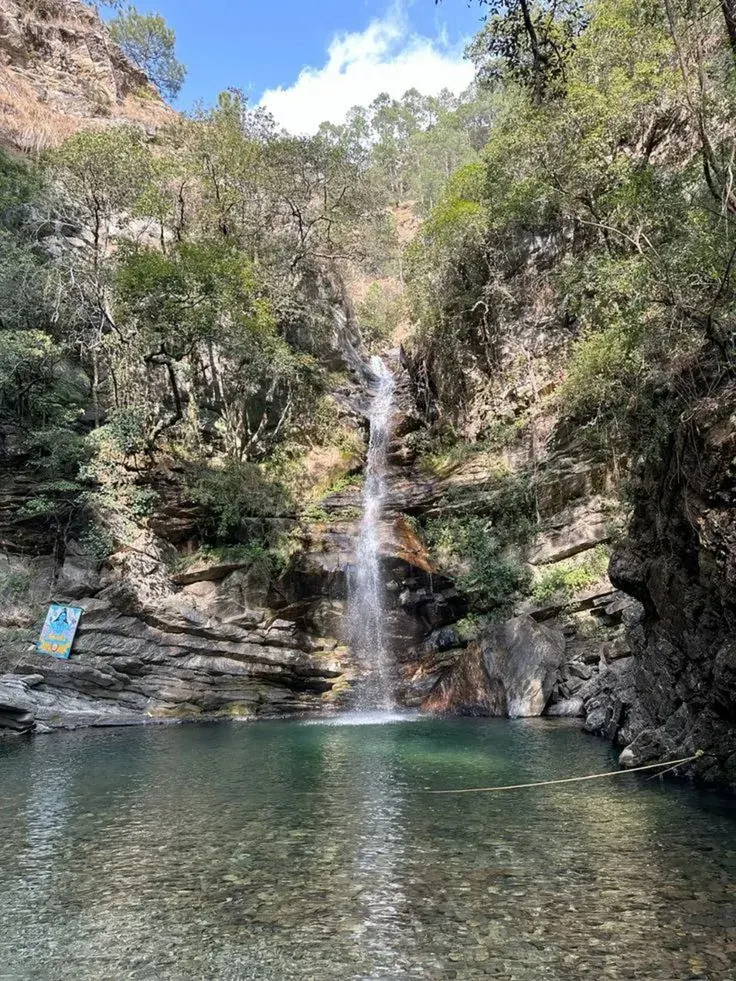 Bhalu Gaad waterfall plunge pool near Mukteshwar surrounded by pine and oak trees