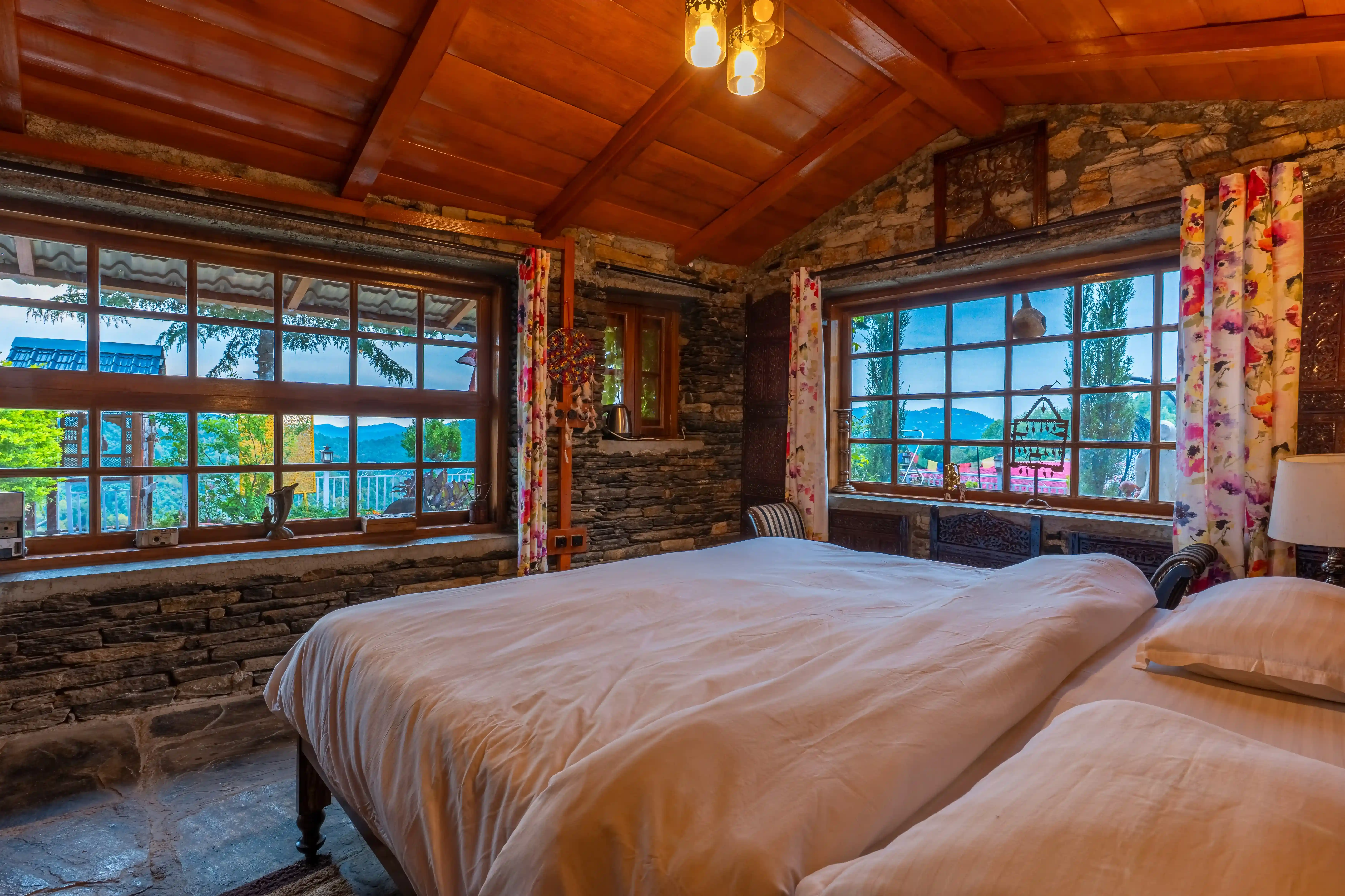 The Vintage Room interior with classic wooden furniture and cozy bedding at Stone Heritage Mukteshwar